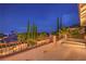Wide patio with iron railing shows backyard trees and sunset views at 2982 Hammerwood Dr, Las Vegas, NV 89135