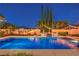 Night view of a stunning backyard pool and spa area with custom lighting and lush landscaping at 2982 Hammerwood Dr, Las Vegas, NV 89135
