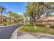 Picturesque street view of homes with mature landscaping and neighborhood signage at 2982 Hammerwood Dr, Las Vegas, NV 89135