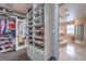 Large walk-in closet with custom shelving and shoe racks leading to the bathroom at 2982 Hammerwood Dr, Las Vegas, NV 89135