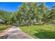 Scenic walking path lined with mature trees and green grass, perfect for an outdoor stroll at 2982 Hammerwood Dr, Las Vegas, NV 89135