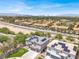 An aerial view shows a neighborhood featuring homes with solar panels, tile roofs and landscaped yards with city views at 3204 Rutledge Dr, Las Vegas, NV 89120
