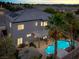 Aerial view of a home with a sparkling pool, tiki bar, lush landscaping, and a covered patio at 3204 Rutledge Dr, Las Vegas, NV 89120