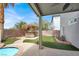 Beautiful backyard featuring a tiki bar, pool, and lush landscaping for outdoor enjoyment at 3204 Rutledge Dr, Las Vegas, NV 89120