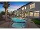 Backyard oasis featuring a sparkling pool, hot tub, and a charming tiki bar area at 3204 Rutledge Dr, Las Vegas, NV 89120