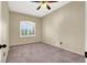 A cozy bedroom with neutral walls, plush carpet, natural light, and a ceiling fan at 3204 Rutledge Dr, Las Vegas, NV 89120