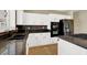 Kitchen features white cabinets, granite countertops, stainless steel appliances, and tile backsplash at 3204 Rutledge Dr, Las Vegas, NV 89120
