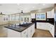 Open-concept kitchen with a large island, white cabinetry, recessed lighting, and direct access to the living area at 3204 Rutledge Dr, Las Vegas, NV 89120