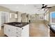 Kitchen island with gas range, white cabinets, and tile flooring overlooking living areas at 3204 Rutledge Dr, Las Vegas, NV 89120