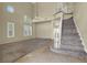 Spacious living room features carpeted and tile flooring with staircase at 3204 Rutledge Dr, Las Vegas, NV 89120
