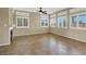 Open-concept living room with a fireplace, tile floors, recessed lighting and multiple windows with white shutters at 3204 Rutledge Dr, Las Vegas, NV 89120