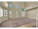 A large, open living space features a vaulted ceiling, expansive windows, and neutral color scheme at 3204 Rutledge Dr, Las Vegas, NV 89120