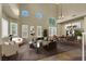 Staged living room with neutral colors, a vaulted ceiling, modern furniture, and ample natural light at 3204 Rutledge Dr, Las Vegas, NV 89120