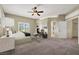 Staged main bedroom with a ceiling fan, fireplace, and neutral colors at 3204 Rutledge Dr, Las Vegas, NV 89120