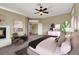 Staged main bedroom featuring a fireplace, seating, and ceiling fan at 3204 Rutledge Dr, Las Vegas, NV 89120