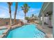 Refreshing pool with a rock waterfall, tiki bar, and lush palm trees for a tropical feel at 3204 Rutledge Dr, Las Vegas, NV 89120