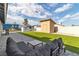 Spacious backyard featuring turf, a storage shed, pavers, and seating area, perfect for outdoor enjoyment at 3682 Deer Creek Way, Las Vegas, NV 89115