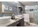 Modern bathroom featuring double sinks, a large mirror, and a glass-enclosed walk-in shower at 3682 Deer Creek Way, Las Vegas, NV 89115