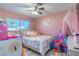 Bright bedroom features a ceiling fan, ample natural light, and playful decor for a cheerful ambiance at 3682 Deer Creek Way, Las Vegas, NV 89115