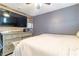 Cozy bedroom features modern finishes, a large wall mounted TV, and plenty of space at 3682 Deer Creek Way, Las Vegas, NV 89115