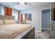 Cozy bedroom with a large bed, mirrored closet doors, neutral tones, and soft lighting at 3682 Deer Creek Way, Las Vegas, NV 89115