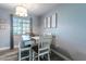 Light and airy dining room with a window view, simple decor, and modern farmhouse-style table at 3682 Deer Creek Way, Las Vegas, NV 89115