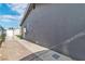 The home's exterior is sleek with gray paint, air conditioning, and brick and gravel flooring at 3682 Deer Creek Way, Las Vegas, NV 89115