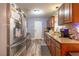 Bright kitchen featuring stainless steel appliances, wood cabinets, and granite countertops at 3682 Deer Creek Way, Las Vegas, NV 89115