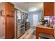 Well-lit kitchen featuring stainless steel appliances, wood cabinets, and granite countertops at 3682 Deer Creek Way, Las Vegas, NV 89115