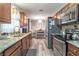 Spacious kitchen with stainless steel appliances and view to the dining room with modern table set at 3682 Deer Creek Way, Las Vegas, NV 89115