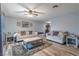 Spacious living room featuring stylish decor, wood flooring, plush seating, and a ceiling fan at 3682 Deer Creek Way, Las Vegas, NV 89115