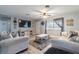 Comfortable living room with modern decor, plush seating, ceiling fan, and large screen television at 3682 Deer Creek Way, Las Vegas, NV 89115