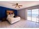 Bright bedroom featuring tile floors, a ceiling fan, and sliding door access to the patio at 3766 Colonial Dr, Las Vegas, NV 89121