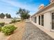 Well-maintained backyard with stone pathway, bushes, and multiple points of entry into the home at 3957 Placita Del Lazo, Las Vegas, NV 89120