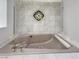 Elegant soaking tub featuring custom tile work and decorative glass inlay at 3957 Placita Del Lazo, Las Vegas, NV 89120