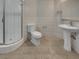 Bright bathroom featuring a tiled shower stall and pedestal sink at 3957 Placita Del Lazo, Las Vegas, NV 89120