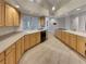 Well-lit kitchen with tile flooring, light wood cabinetry, and plenty of countertop space at 3957 Placita Del Lazo, Las Vegas, NV 89120
