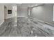 Open concept living room featuring marble flooring, a fireplace, and natural light at 3957 Placita Del Lazo, Las Vegas, NV 89120