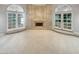 Spacious room with marble fireplace, carpeted floors and French doors letting in ample natural light at 3957 Placita Del Lazo, Las Vegas, NV 89120