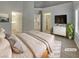 Serene main bedroom features a tiled floor, tv, and ensuite bathroom at 3957 Placita Del Lazo, Las Vegas, NV 89120