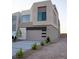 Modern home featuring a minimalist design, concrete driveway, and a two-car garage at 3980 Heron Fairway Dr, Las Vegas, NV 89141