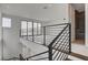 An elegant loft area with modern metal railings, tiled bathroom and an abundance of natural light flowing through the large windows at 3980 Heron Fairway Dr, Las Vegas, NV 89141
