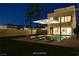Inviting backyard with a sparkling pool, lounge chairs, palm trees, and modern home design at 3980 Heron Fairway Dr, Las Vegas, NV 89141