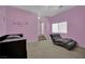Bedroom with pink walls, carpet, a bed and a lounge chair at 4139 Abernethy Forest Pl, Las Vegas, NV 89141