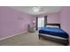 Bedroom with pink walls, carpet, a bed and chair at 4139 Abernethy Forest Pl, Las Vegas, NV 89141