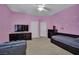 Bedroom with pink walls, carpet, a bed, a tv and a couch at 4139 Abernethy Forest Pl, Las Vegas, NV 89141