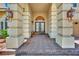 Inviting entrance with decorative pillars, lighting fixtures, and double front doors at 4139 Abernethy Forest Pl, Las Vegas, NV 89141