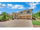 Attractive two-story home with a three-car garage, paver driveway, and well-maintained lawn at 4139 Abernethy Forest Pl, Las Vegas, NV 89141