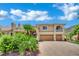 Beautiful two-story home with lush greenery, desert landscaping, and a spacious three-car garage at 4139 Abernethy Forest Pl, Las Vegas, NV 89141