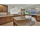 Charming kitchen area showcasing wood cabinets, tile countertops, and a spacious island at 4139 Abernethy Forest Pl, Las Vegas, NV 89141
